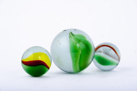 An isolated closeup of glass marbles on white backgroundの写真素材