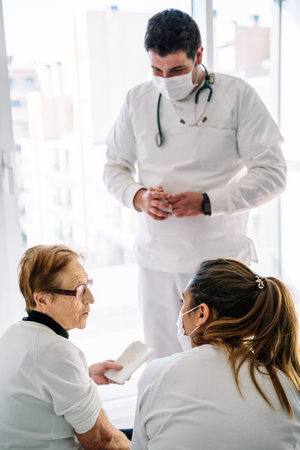 The emergency nursing team visits an elderly woman during the covid pandemicの写真素材