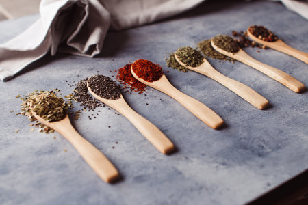 A selective focus shot of assortment of spices: chia, paprika, parsley, rosemary, and teasの写真素材