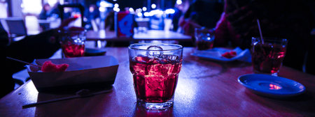 A closeup shot of glass with juice and ice in the cafeの写真素材