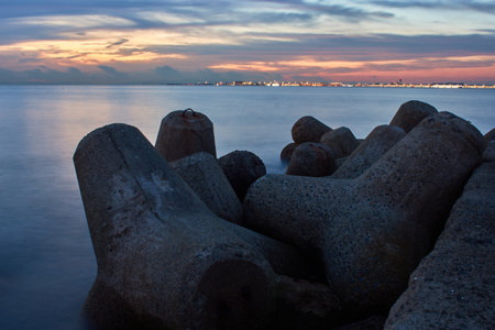 A beautiful view of a seascape with tetrapod breakwaters under the sunset sの写真素材