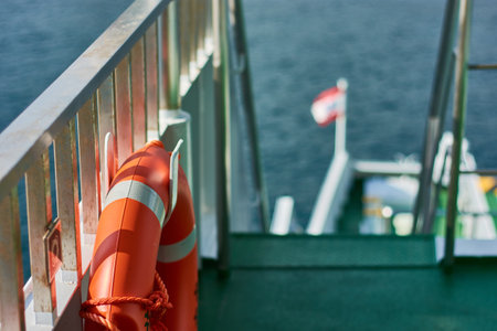 A closeup shot of a lifebuoy on a dock by the seaの写真素材