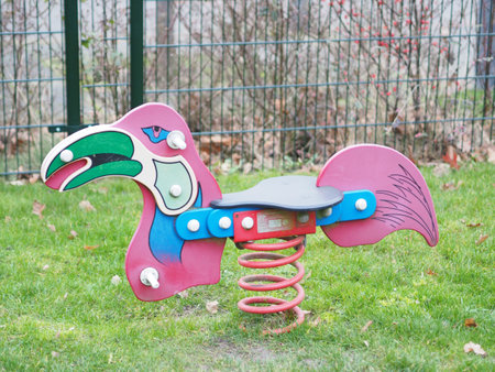 A flamingo shaped rocking chair on playgroundの写真素材