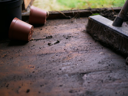 Sweeping brush on dirty timber wooden shed floor medium shotの写真素材