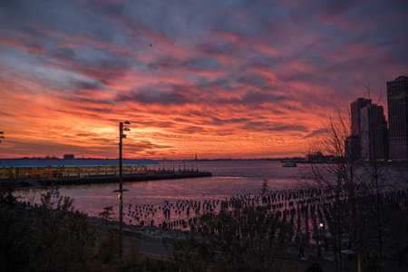 A port near the calm sea under the cloudy sunset skyの写真素材