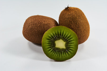 A closeup of fresh kiwis on a white backgroundの写真素材