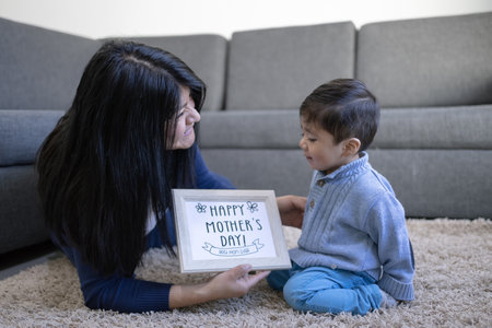 A Mexican mother playing with her son at home - Mother's Day conceptの写真素材