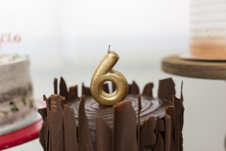 A chocolate cake with a candle for the sixth birthday partyの写真素材