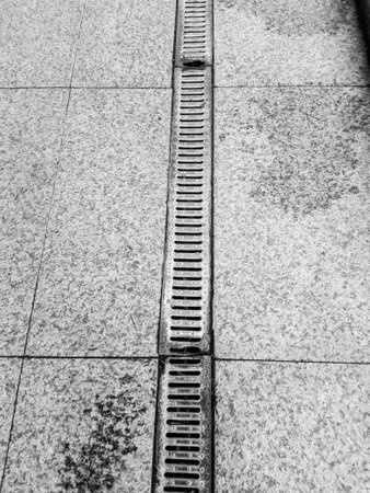 A vertical grayscale shot of a sidewalk in Poznan, Polandの写真素材