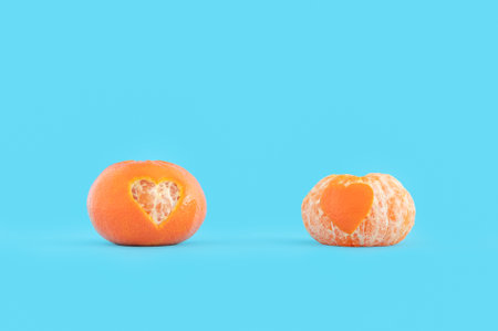 A closeup shot of mandarin oranges with heart shapes on them - Valentine's day conceptの写真素材