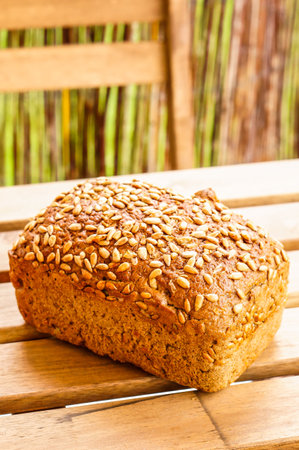 Whole fresh baked bread on a wooden table