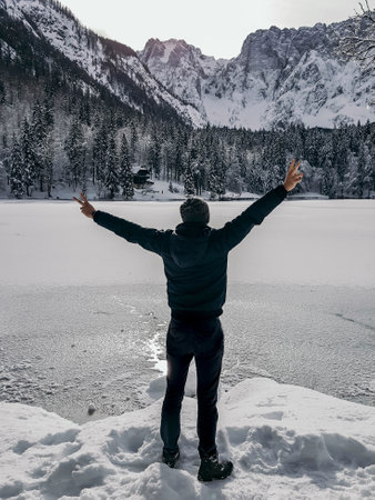 A breathtaking shot of a young male enjoying the beautiful winter landscapeの写真素材