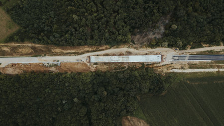 A top view of a road under construction in Brcko district surrounded by forests, Bosnia and Herzegovinaの写真素材