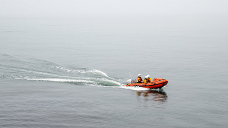 A lifeguard boat with three lifeguarの写真素材