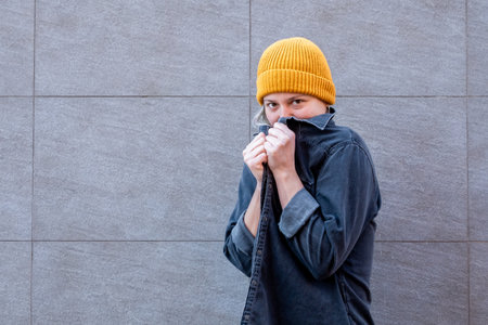A young Caucasian female from Spain covering her face with her shirt - feeling fear
