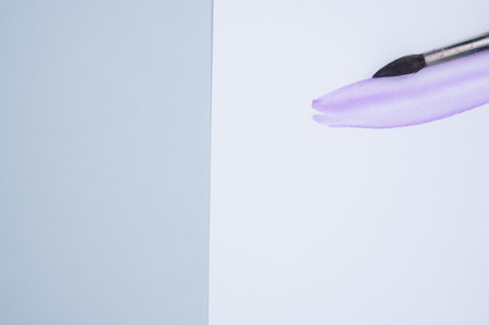 A brush painting on a white paper with purple watercolorの写真素材