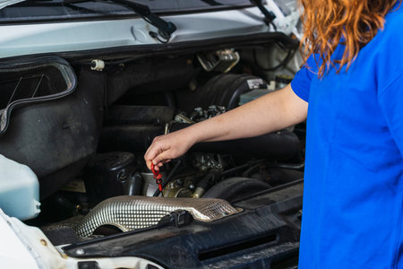 A closeup shot of a female mechanic fixing a car