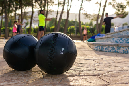 The group of people exercising outdoors in the park - the concept of fitness and sportの写真素材