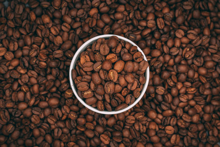 A top view of a cup full of roasted coffee beans - cool for coffee shop wallpaper or backgroundの写真素材