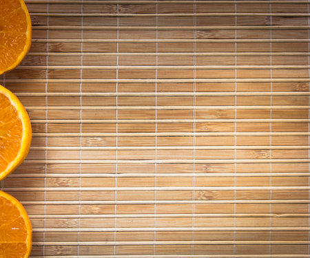 A background design with orange slices on a bamboo cooking mat