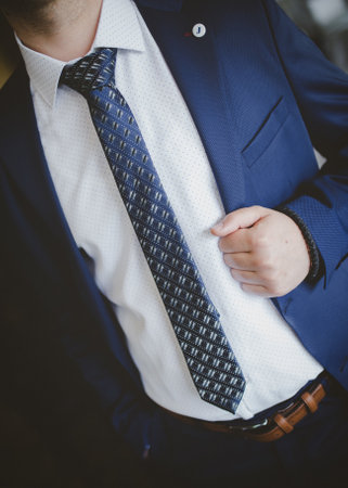 A closeup of a stylish man wearing an elegant classic blue suitの写真素材