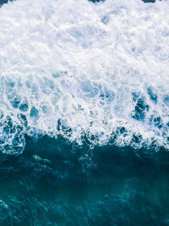 A vertical shot of big waves making white foam - perfect for background