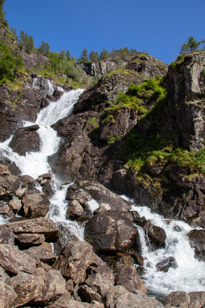 A vertical shot of the Latefossen waterfalls in Norway under a clear sky backgroundの写真素材