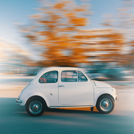 A small white retro car on a blurry backgroundの写真素材
