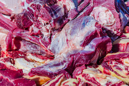 Chunks of fresh beef are on the counter. Traditional autumn fair of agricultural products.