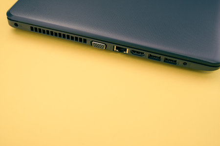 A closeup shot of a personal computer on a yellow backgroundの写真素材