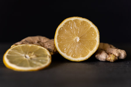 Lemon with ginger in front of black background.