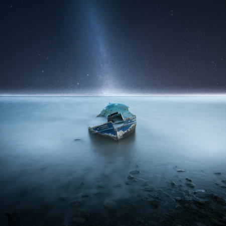 A mysterious abandoned boat in a foggy seaの写真素材