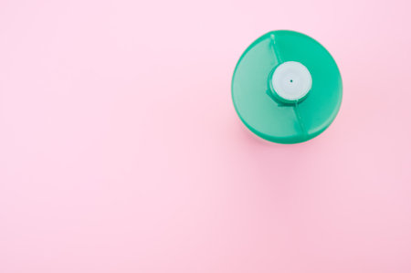 An overhead shot of a green container on a pink backgroundの写真素材