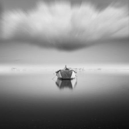 A greyscale shot of an empty old fishing boat inの写真素材