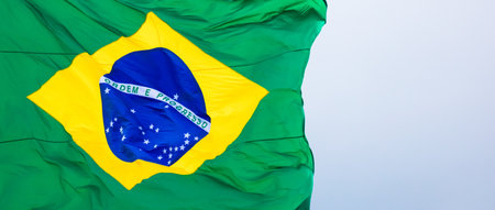 A closeup shot of a Brazil flag waving in the wind