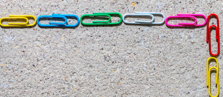 A frame made of colorful paper clips on a stone backgroundの写真素材