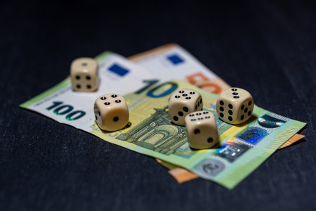Dice lie on euro banknotes. Symbol for gambling debts and gambling addiction. Gambling.の写真素材
