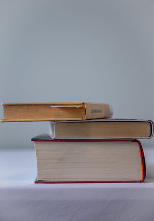 A closeup shot of a stack of books on a table