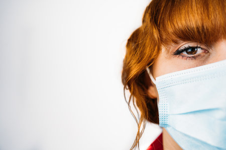 A closeup shot of a female wearing a mask on an isolaâ ed backgroundの写真素材