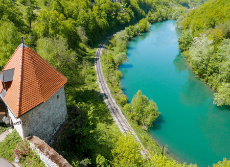 A beautiful high angle view of the water surrounded by a forest and the tower on a sunny dayの写真素材