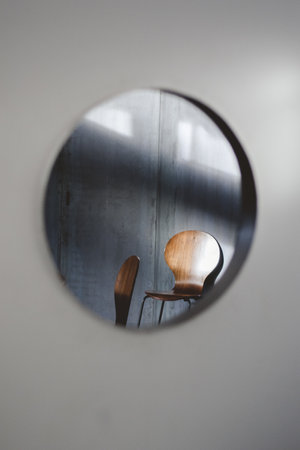 A certical shot of a wooden chair seen through a holeの写真素材