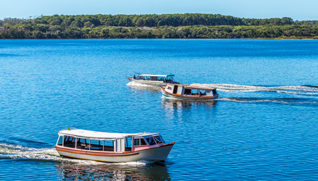 A panoramic shot of boats in a blue lakeの写真素材