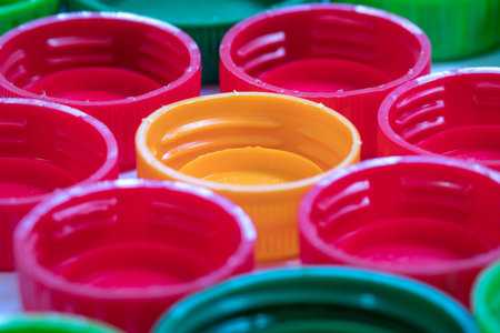 A closeup shot of red plastic lids with yellow in the middle for recycling
