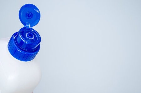 A closeup of a plastic bottle with a blue cap isolated on a white backgroundの写真素材