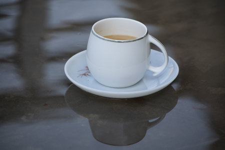 A closeup of a cup of coffee on a plateの写真素材