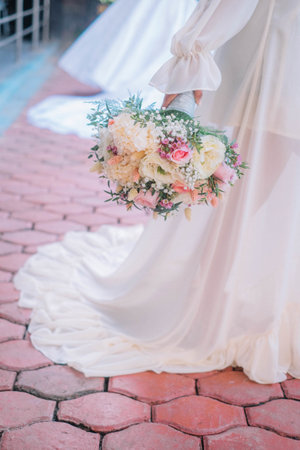 A beautiful soft bouquet in the hand of the brideの写真素材