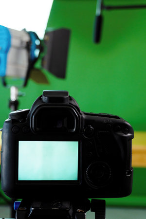 A professional video camera with a microphone in a studio