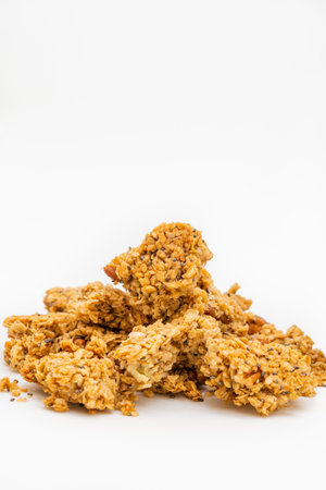 A pile of granola cereal made from oats and chia seeds isolated on white background