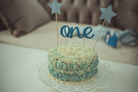 One year Birthday Cake on blue text