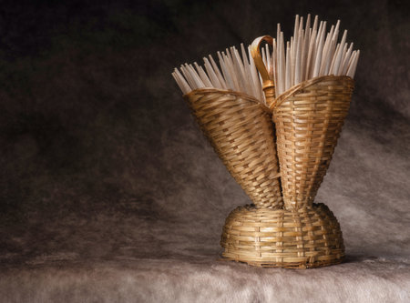 A Wooden toothpick container scene on a Fine Art background. Wicker toothpick holderの写真素材